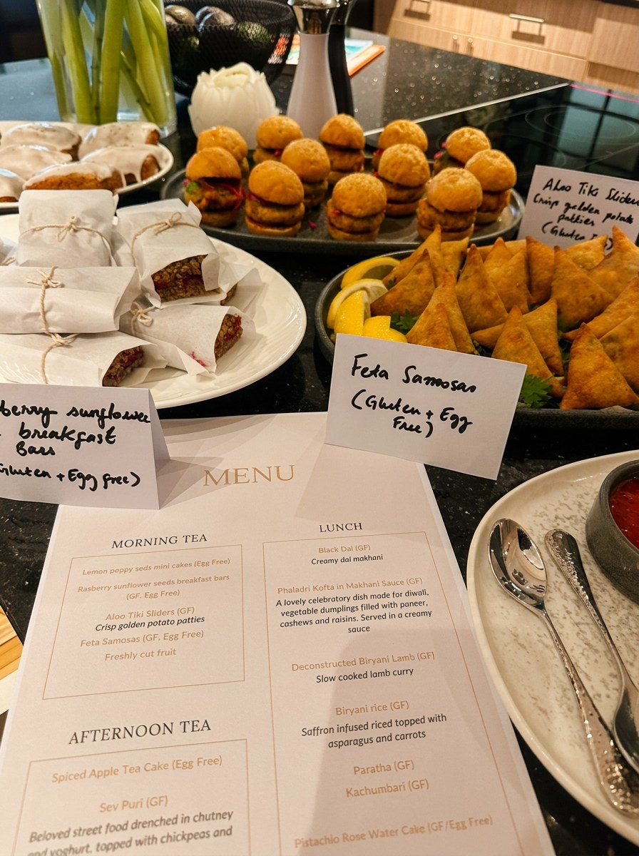 Canapés and printed menu — feta samosas, sliders, breakfast bars